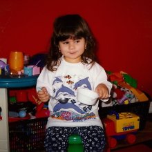 Julia as a child playing with toys
